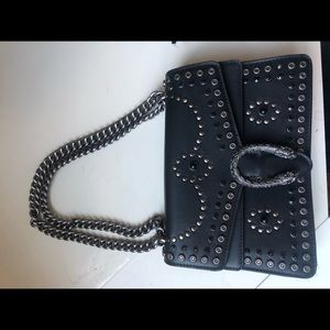 Studded black horseshoe bag